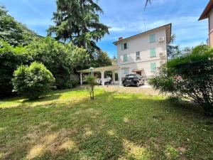 a house with a car parked in the yard at Urban Apartments RE in Reggio Emilia