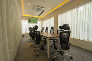 a conference room with a long table and chairs at Tiger Hill Hotel & Suites in Kalpetta