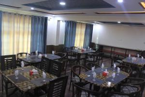 a dining room with tables and chairs and a whiteboard at cloudrestskardu in Skardu