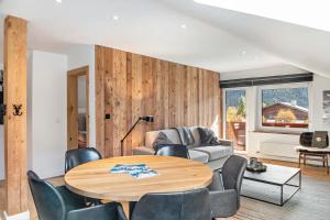 a living room with a table and chairs at Alpin Haus Berwang in Berwang