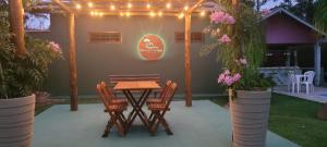 a patio with a table and chairs and lights at Pousada Casa de Campo in Conservatória