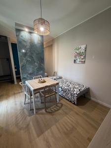 a dining room with a table and a bed at Sciuri House in CTA +38 photos