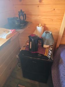 a coffee maker sitting on a table in a room at Cozy Summer House with Free Parking near Town Center & Beach in Kuressaare