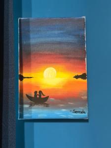 a painting of two people in a boat at sunset at Sciuri House in CTA