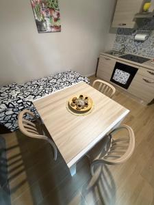 a table and chairs in a kitchen with a bed at Sciuri House in CTA