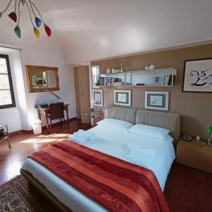 a bedroom with a large white bed in a room at La Canonica della Merella B&B in Novi Ligure