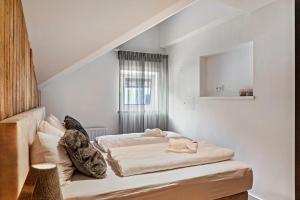a bedroom with a bed and a window in it at Alpin Haus Berwang in Berwang