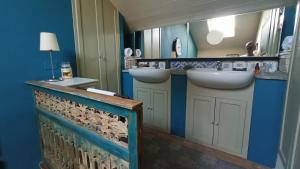 a bathroom with two sinks and a mirror at La Canonica della Merella B&B in Novi Ligure +122 photos
