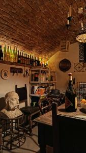 a room with a bar with a bust on a table at La Canonica della Merella B&B in Novi Ligure