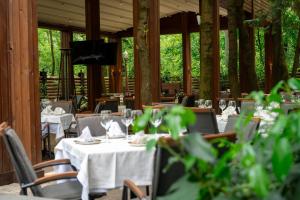 a dining room with tables and chairs with white table cloth at Villa VICTORIA Loven Park Boutique Rooms Sofia in Sofia