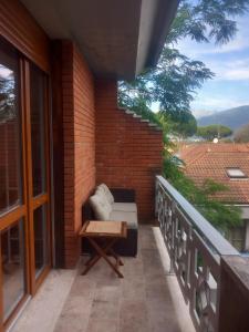 a balcony with a couch on a brick wall at Lorimare in Marina di Massa