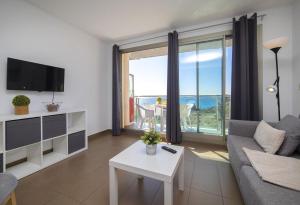 a living room with a view of the ocean at Homeincalpe Borumbot in Calpe