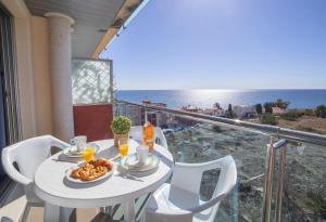 a table with a plate of food on a balcony at Homeincalpe Borumbot in Calpe