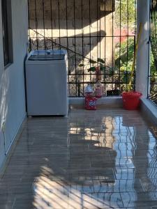 a front door with a trash can on a patio at casa Verano in Cabarete