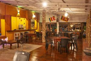 a restaurant with wooden floors and tables and chairs at That's Why Nilaveli Beach Cabanas in Trincomalee +49 photos