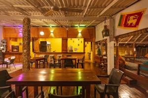 a restaurant with tables and chairs in a room at That's Why Nilaveli Beach Cabanas in Trincomalee