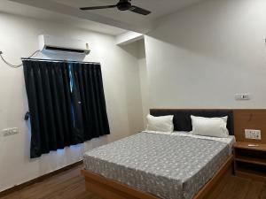 a bedroom with a bed with a black curtain at Hotel RK Palace in Sehot
