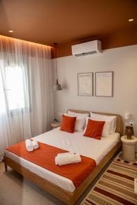 a bedroom with a large bed with towels on it at CASA Terraya in Afantou +12 photos