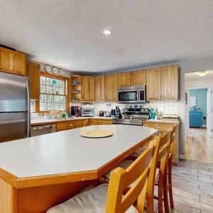 a large kitchen with a large white counter top at Bay Pointe Bungalow in East Falmouth