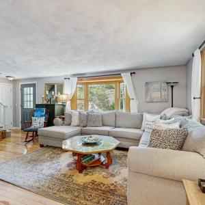 a living room with a couch and a table at Bay Pointe Bungalow in East Falmouth