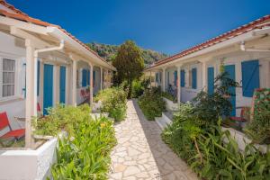 a row of houses with plants in the courtyard at Blue White House in Kalamitsi