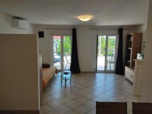 a living room with a bed and a table at Cesarica Studio near sea in Cesarica +19 photos