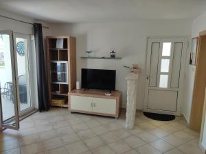 a living room with a flat screen tv on a stand at Cesarica Studio near sea in Cesarica