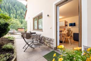 a patio with a table and chairs in a house at Residence Frea in Selva di Val Gardena