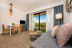 a living room with a couch and a dining room at Apartamentos Sinfony in Canyamel
