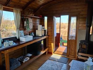 a kitchen with a sink and a stove in a cabin at hillgate farm lodges in Godney Hill