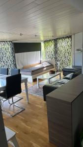 a room with a couch and a table and chairs at Sia Home in Vålberg