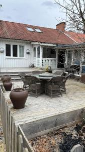 a patio with a table and chairs and a house at Sia Home in Vålberg
