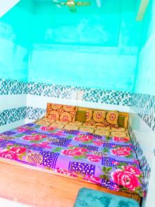 a bed in a room with a tiled wall at Hotel NAR NARAYANA in Chutwāpīpal