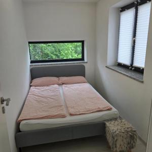a small bedroom with a bed with a window at ALLGÄU SONNENSEITE am ALPSEE -BERGE-SKI in Immenstadt im Allgäu +3 photos