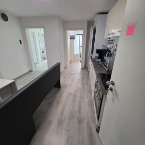 a kitchen with white walls and a wooden floor at ALLGÄU SONNENSEITE am ALPSEE -BERGE-SKI in Immenstadt im Allgäu