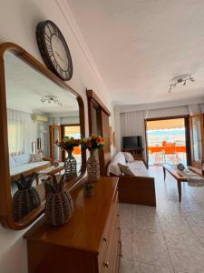 a large mirror on the wall of a living room at Thalia Sea View Apartment in Nea Peramos