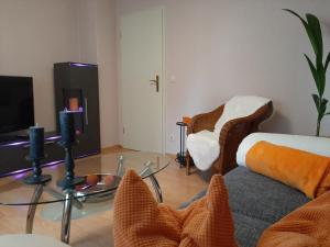 a living room with a couch and a glass table at Eigentumswohnung Nähe See in Pirna