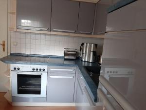 a kitchen with a white stove and a sink at Eigentumswohnung Nähe See in Pirna +9 photos
