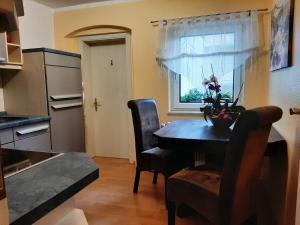 a kitchen with a table and chairs and a window at Eigentumswohnung Nähe See in Pirna