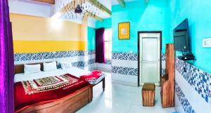 a bedroom with a bed and a tv in it at Hotel NAR NARAYANA in Chutwāpīpal
