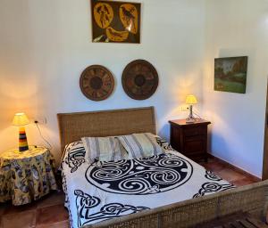 a bedroom with a bed and two lamps on the wall at Cortijo Zalamea in Zalamea la Real +51 photos