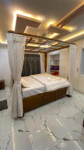 a bed with a canopy in a room with marble floors at Vihari Luxury Resort in Alamanda