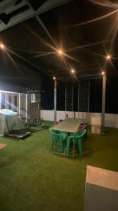 a ping pong table in a large room with lights at Vihari Luxury Resort in Alamanda