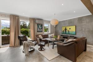 a living room with couches and a table at Hus i Stryn med utsikt in Stryn