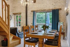 a dining room with a wooden table and chairs at Gîtes Du Logis De Bourseguin in Bourneau