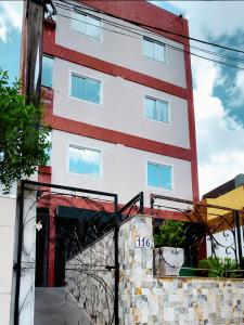 a building with a bridge in front of it at Aldenora Flats in Fortaleza +4 photos