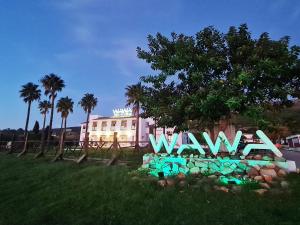 a sign that says wave in front of a building at Wawa Tarifa in Tarifa