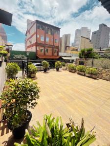 a balcony with potted plants and a building at Aldenora Flats in Fortaleza