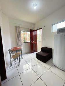 a living room with a table and a couch at Aldenora Flats in Fortaleza