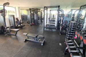 a gym with several treadmills and machines at Frontline Golf Penthouse Lagoon & SPA – EHHouse in Estepona